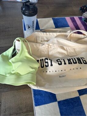 Just Strong Cream Canvas Tote Bag with Black Logo with bra and protein shaker